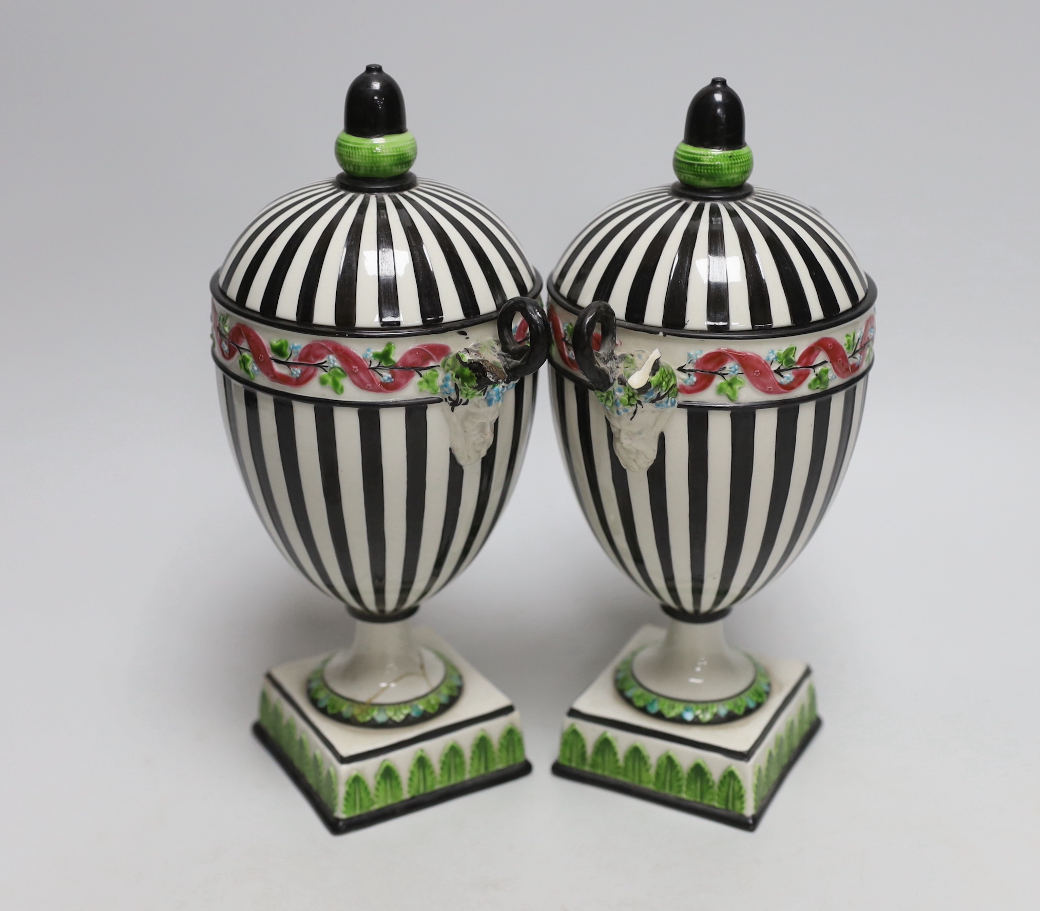 A pair of Wedgwood urns with twin handles and acorn design knops, each 22cm high